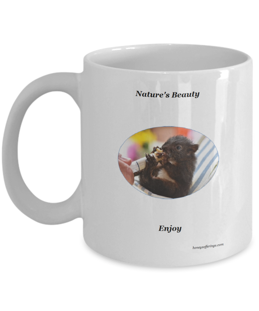 Natures Beauty Coffee Mug with Baby Squirrel being hand fed by loving human.